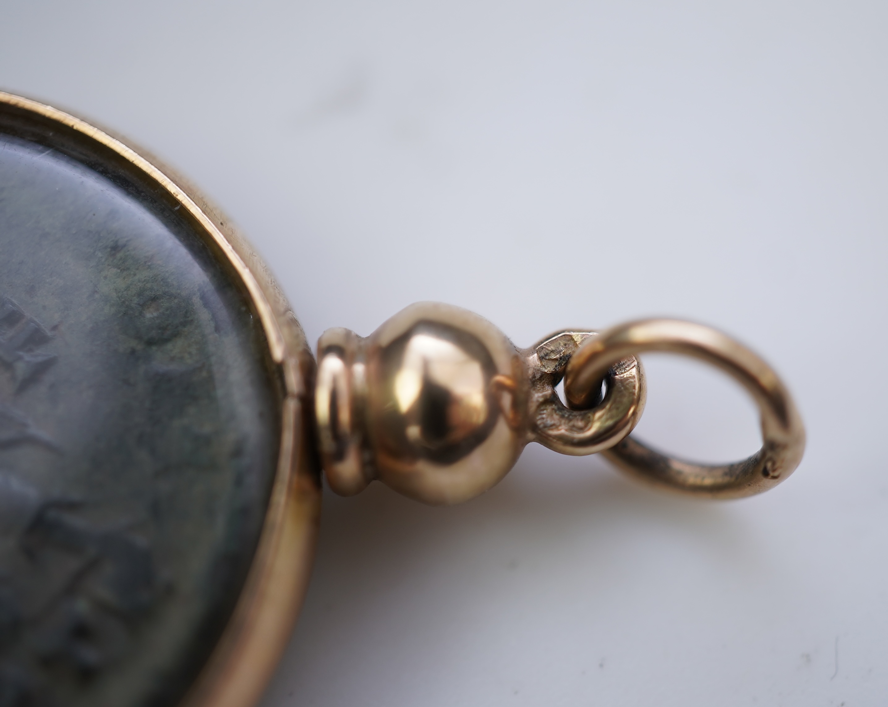A gold and Roman bronze coin pendant